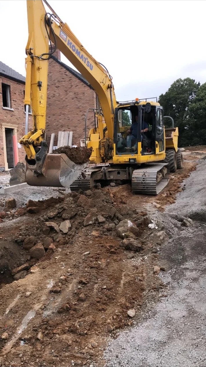 DGB machinery working on excavation beside a new home